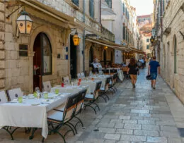 Dubrovnik, Croatia, July 25, 2020: Restaurant tables at a narrow street in the old town of Dubrovnik, Croatia