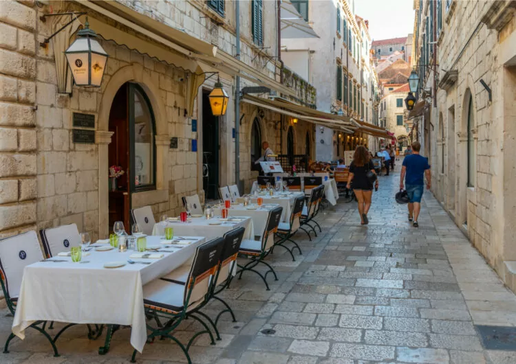 Dubrovnik, Croatia, July 25, 2020: Restaurant tables at a narrow street in the old town of Dubrovnik, Croatia