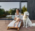 Frau mit Hund auf der Terrasse