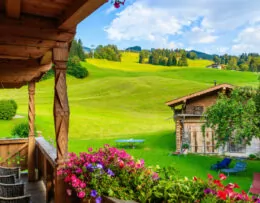 Blick vom Balkon auf grüne Wiese und Berge, Sommertag in Kirchberg, Kitzbühel Alpen, Österreich